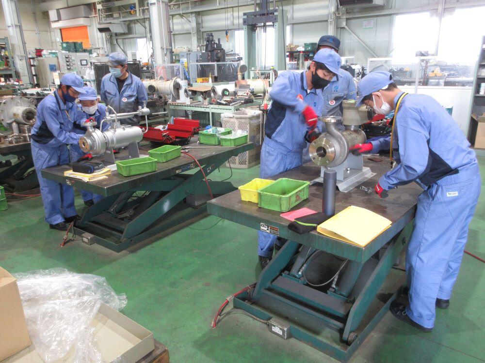 Disassembling and inspecting pumps in the Service Department.